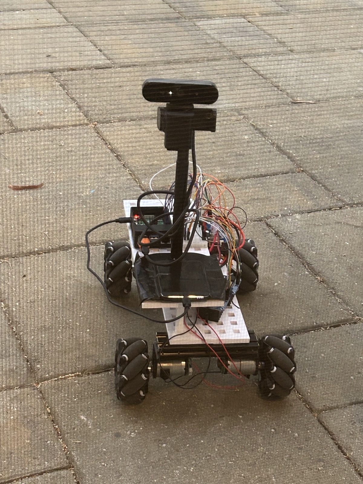 Follow-Me Rover prototype: mecanum base, camera on a mast, Raspberry Pi and motor drivers